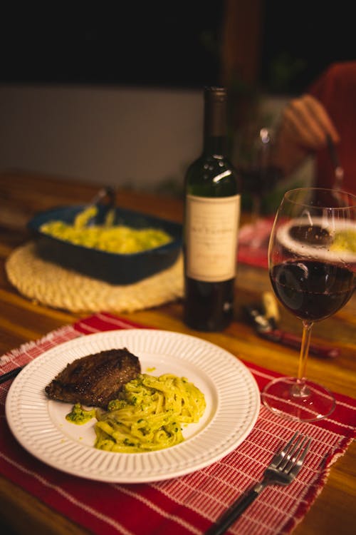 Free Steak with Pasta and a Glass of Red Wine Stock Photo