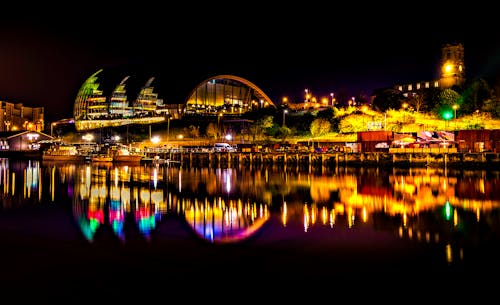 Lighted Buildings Near Body Of Water