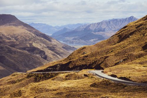 Free Picturesque view of Cardrona Valley with winding roads and rugged mountains in Otago, New Zealand. Stock Photo