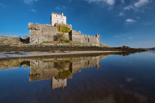 Photo of a Concrete Castle Beside Body of Water