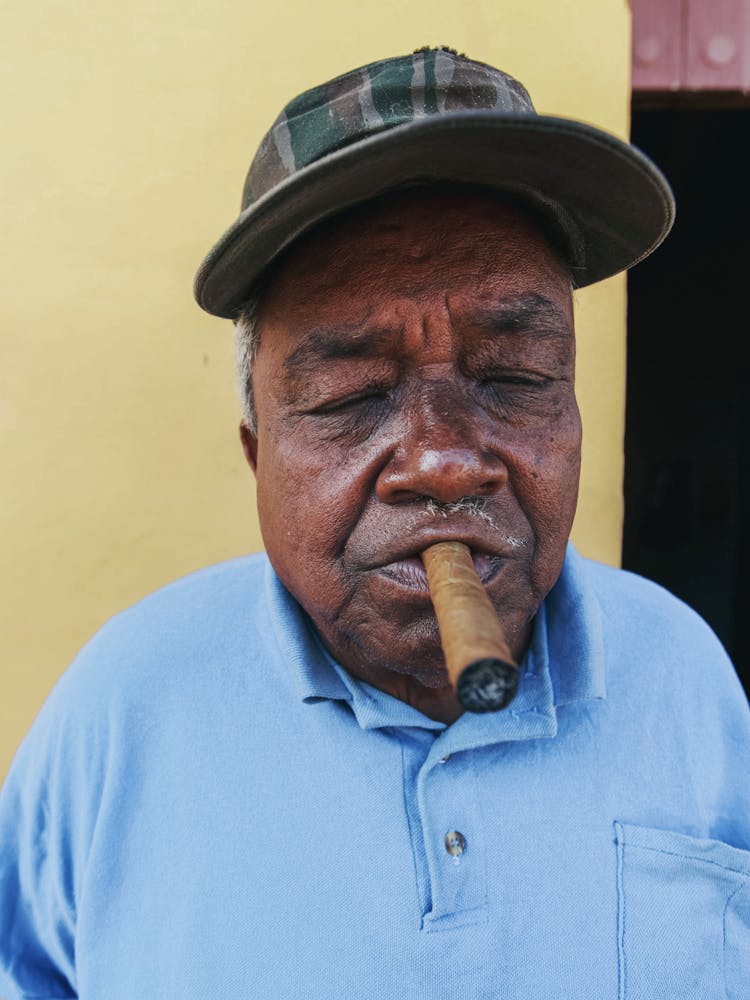 Elderly Man Smoking A Cigar 