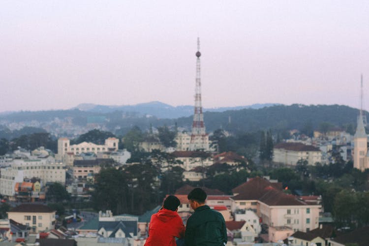 Two People Overlooking The View Of City