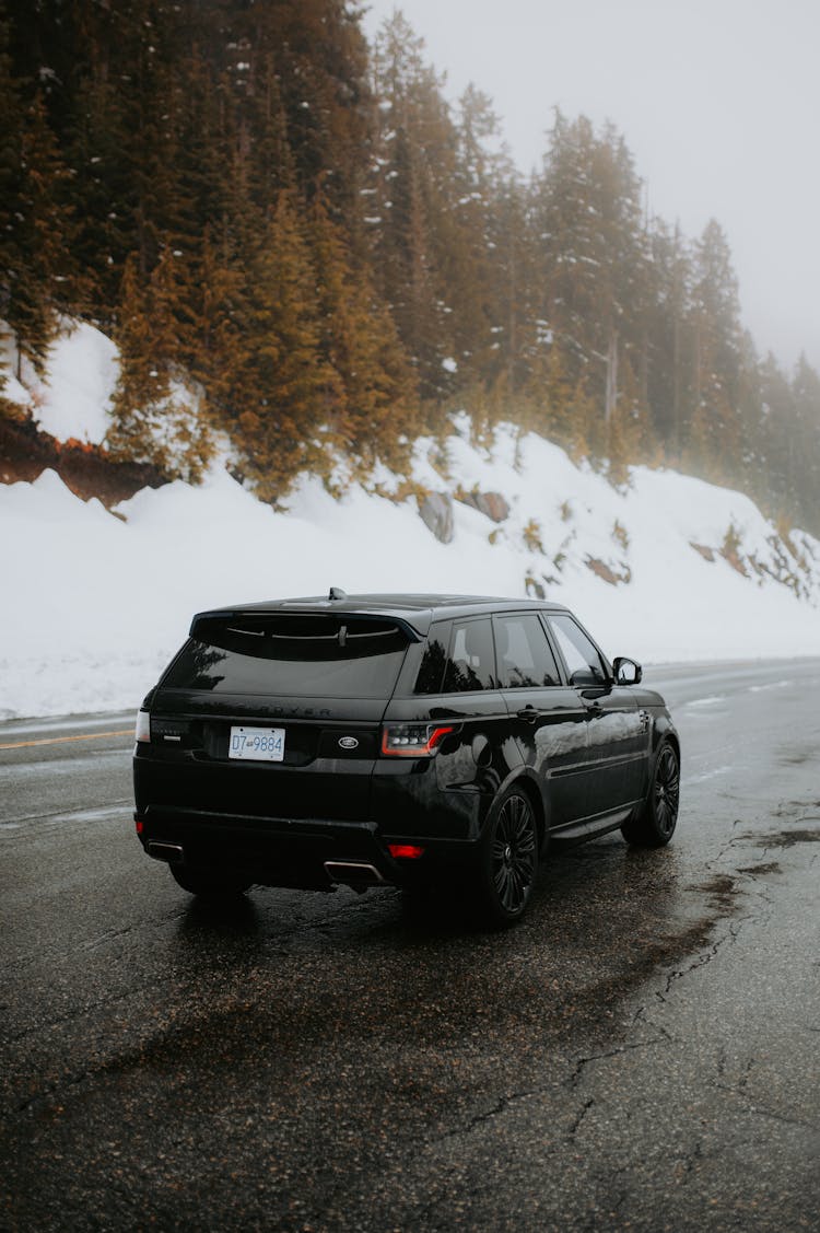 Black SUV Car On The Winter Road 