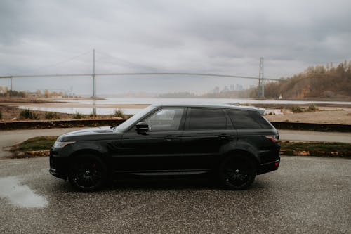 Black Range Rover Sport Car with Lions Gate Bridge in Background