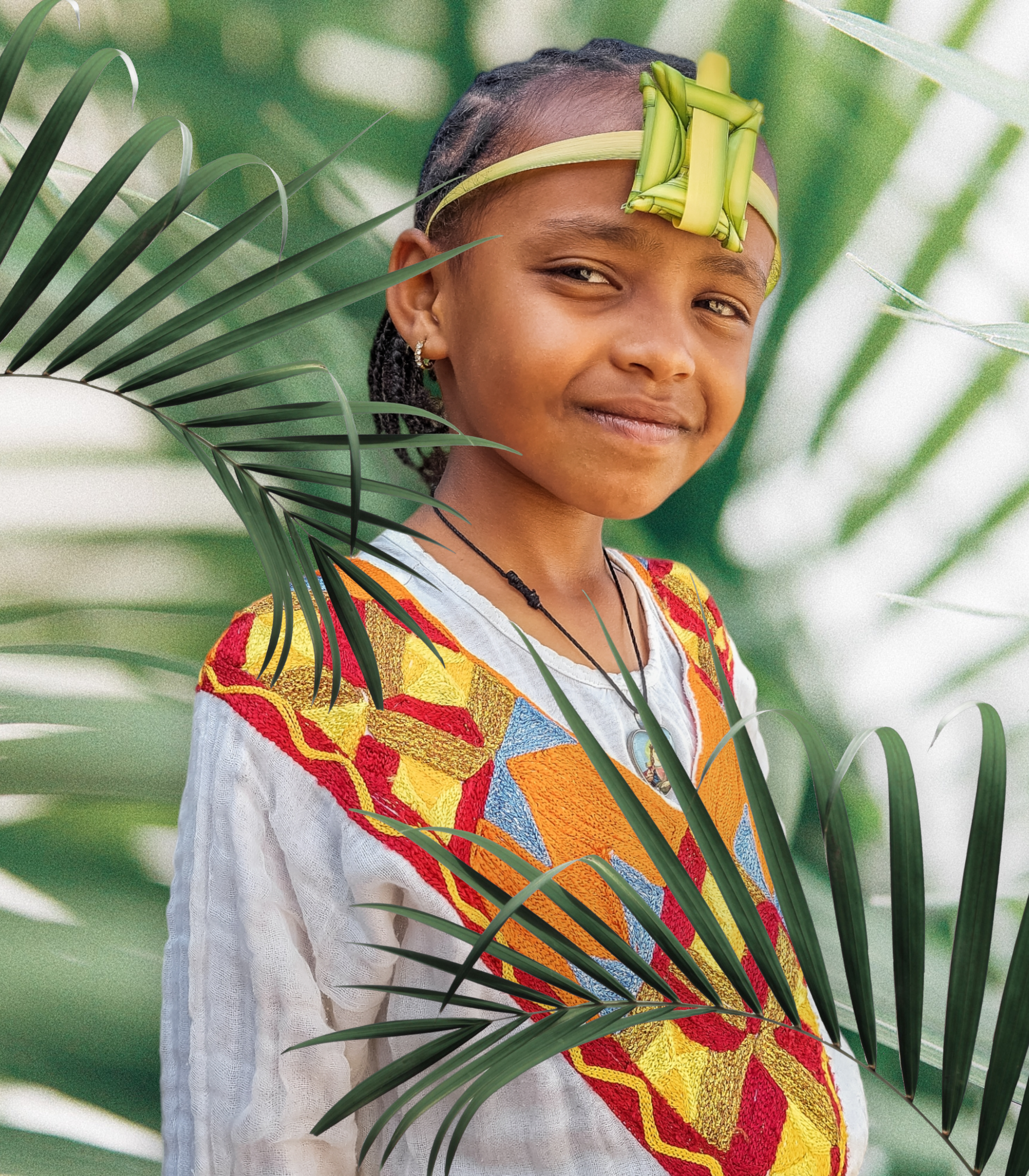 Smiling child wearing traditional attire and head decoration, surrounded by vibrant green leaves.