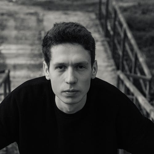 Free Black and White Portrait of a Young Brunette Man in Black T-shirt Stock Photo