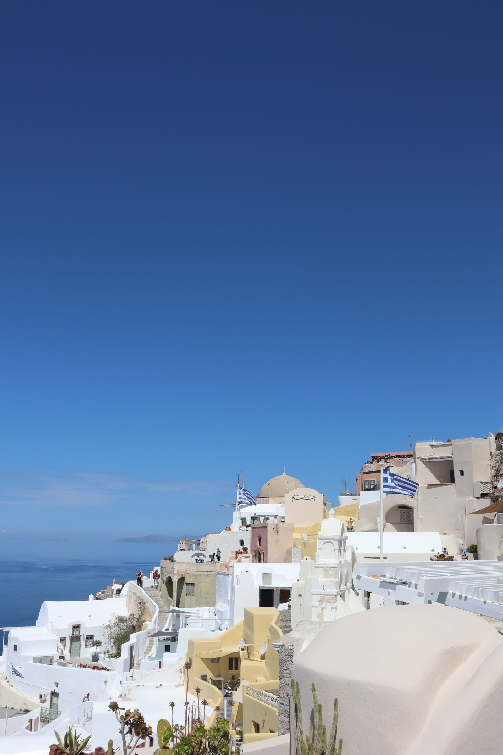 Whitewashed houses of Oia cascading toward the caldera in Santorini