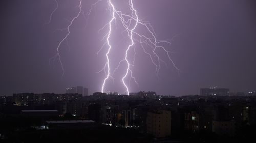 Free Dramatic night scene of lightning striking over the cityscape of Hyderabad, India. Stock Photo