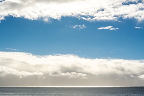 View of a Sea under a Blue Sky with White Clouds 