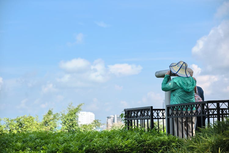 Woman In Jacket Looking Through Binoculars