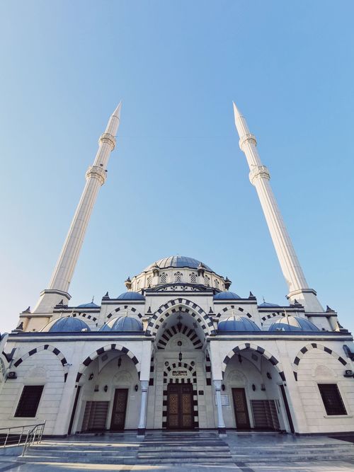 Free Stunning low-angle view of a mosque with domes and minarets, showcasing Ottoman architecture. Stock Photo