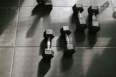 Hex dumbbells on a sunlit gym floor — photo by Anete Lusina on Pexels