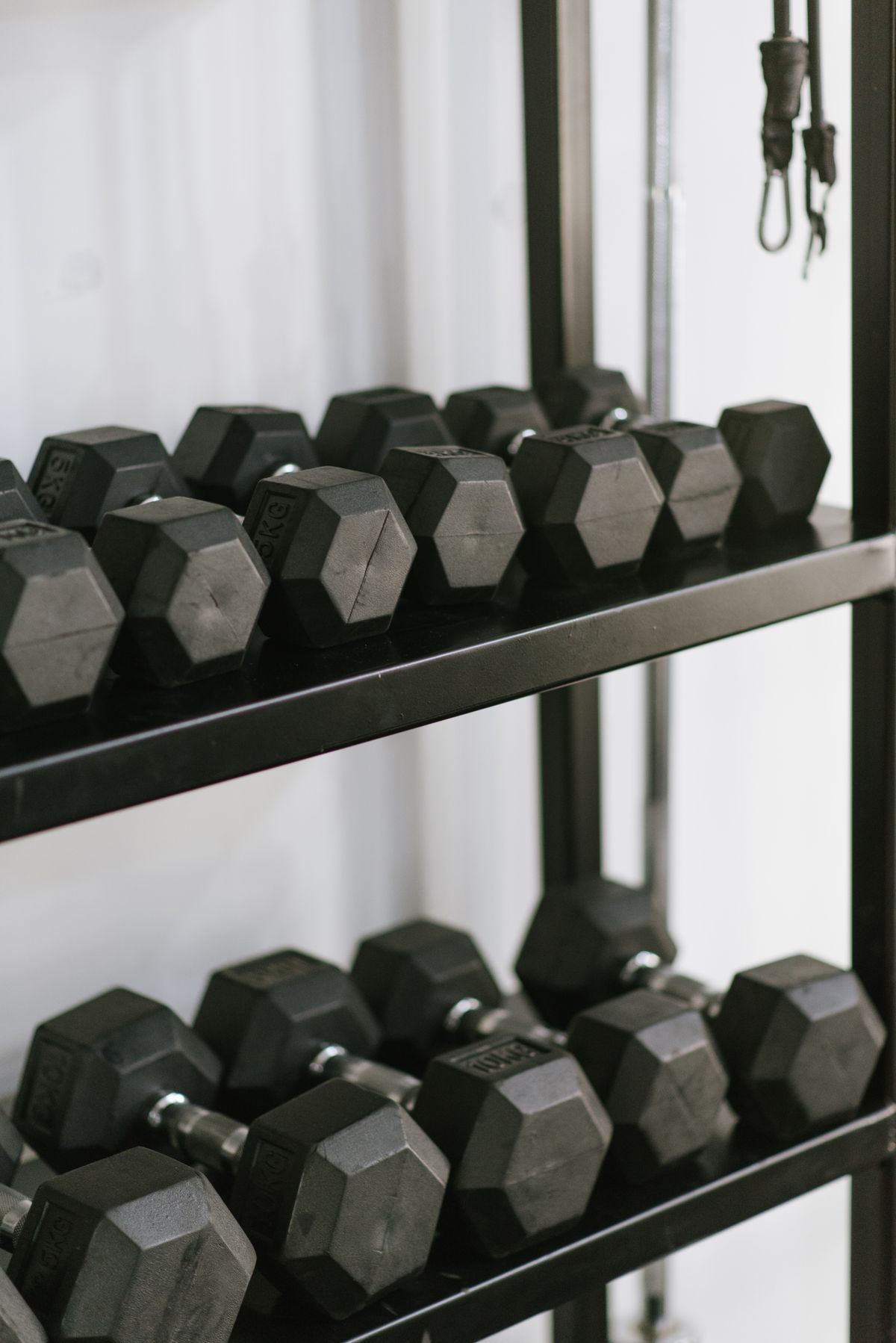 Rack of black hex dumbbells