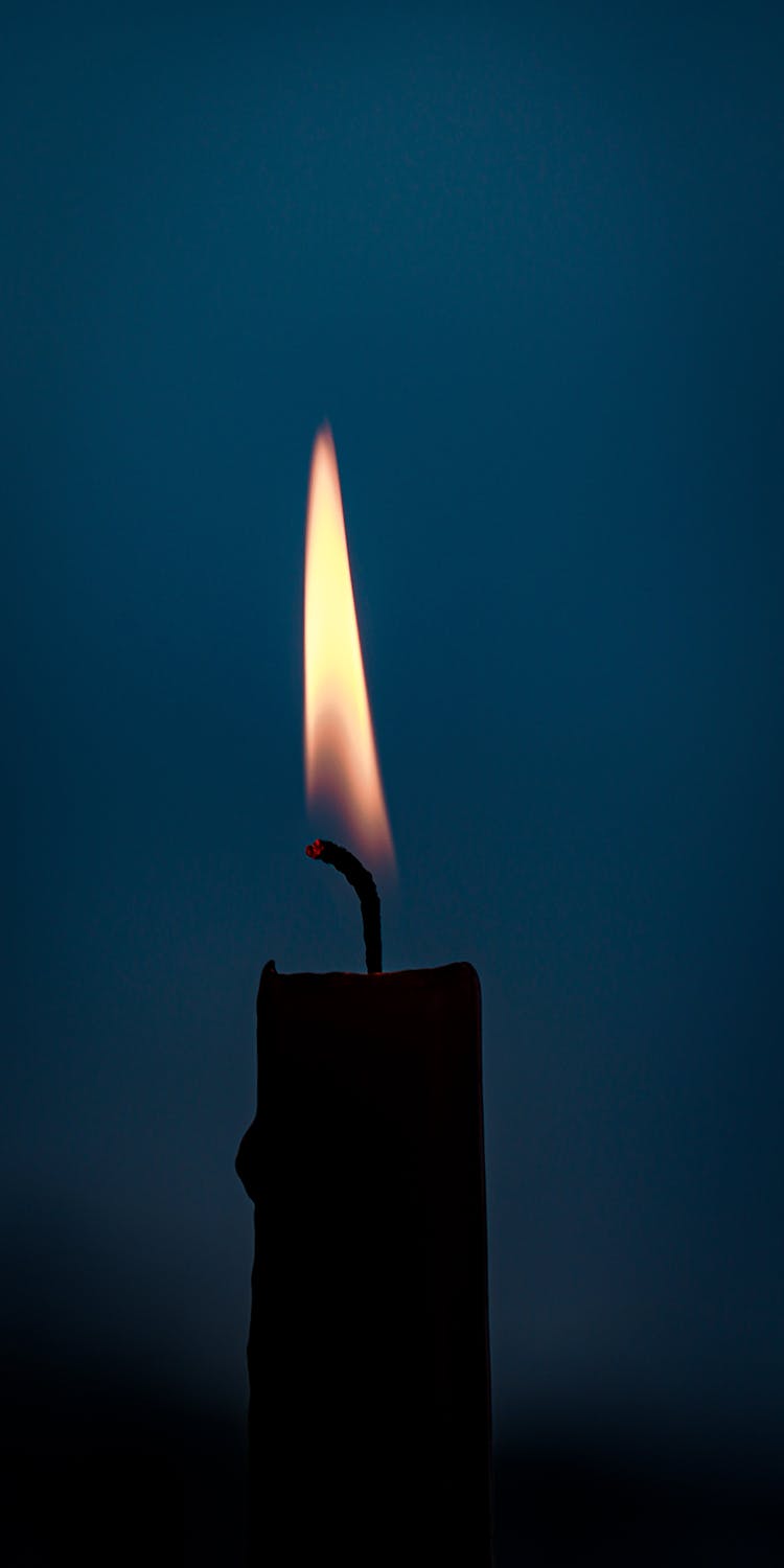 Burning Candle In Dark