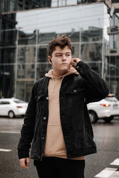 Stylish young man in casual wear in Kyiv city, showcasing urban fashion.
