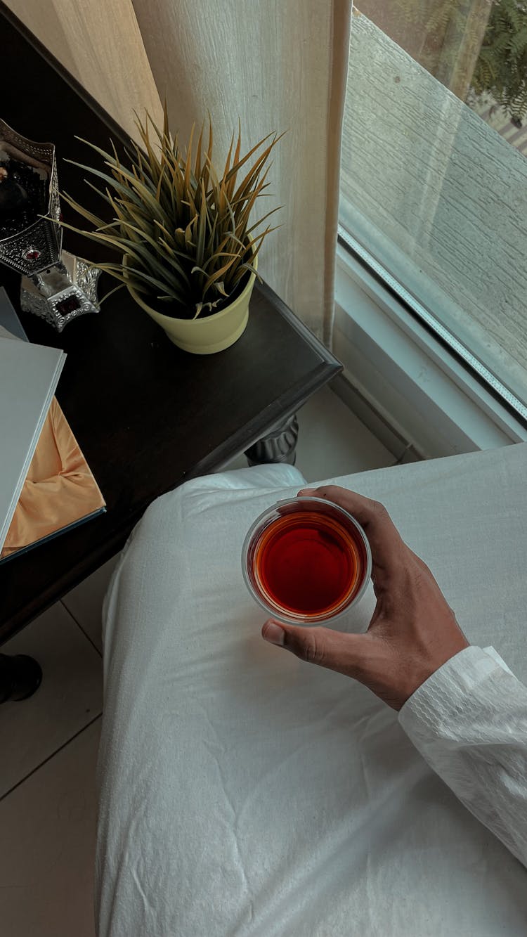 Hand Holding Glass Of Tea