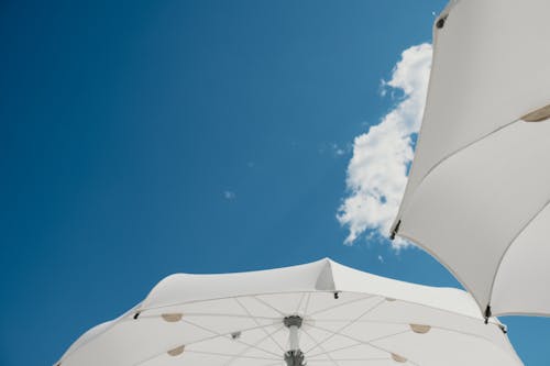 Free Blue Sky over White Umbrellas Stock Photo