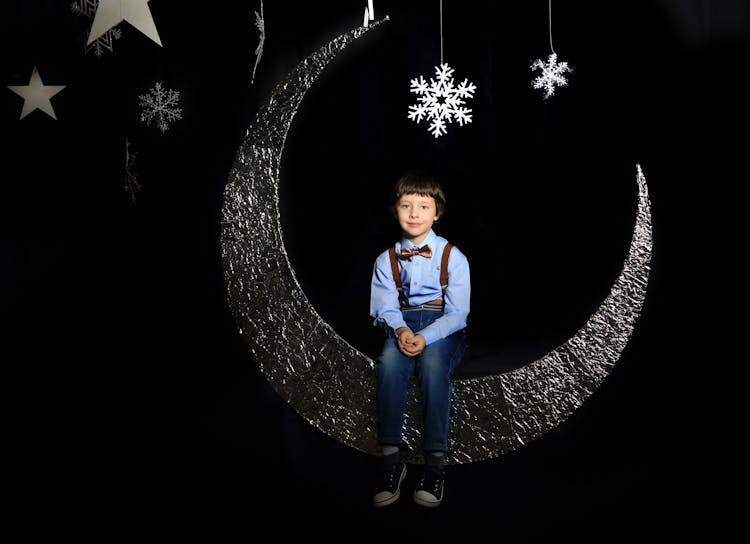 Boy Sitting On Moon Decor