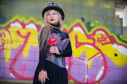 Photo of Woman Standing Near a Wall With Graffiti