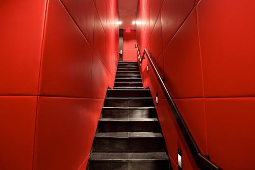 A Narrow Staircase between Red Walls 