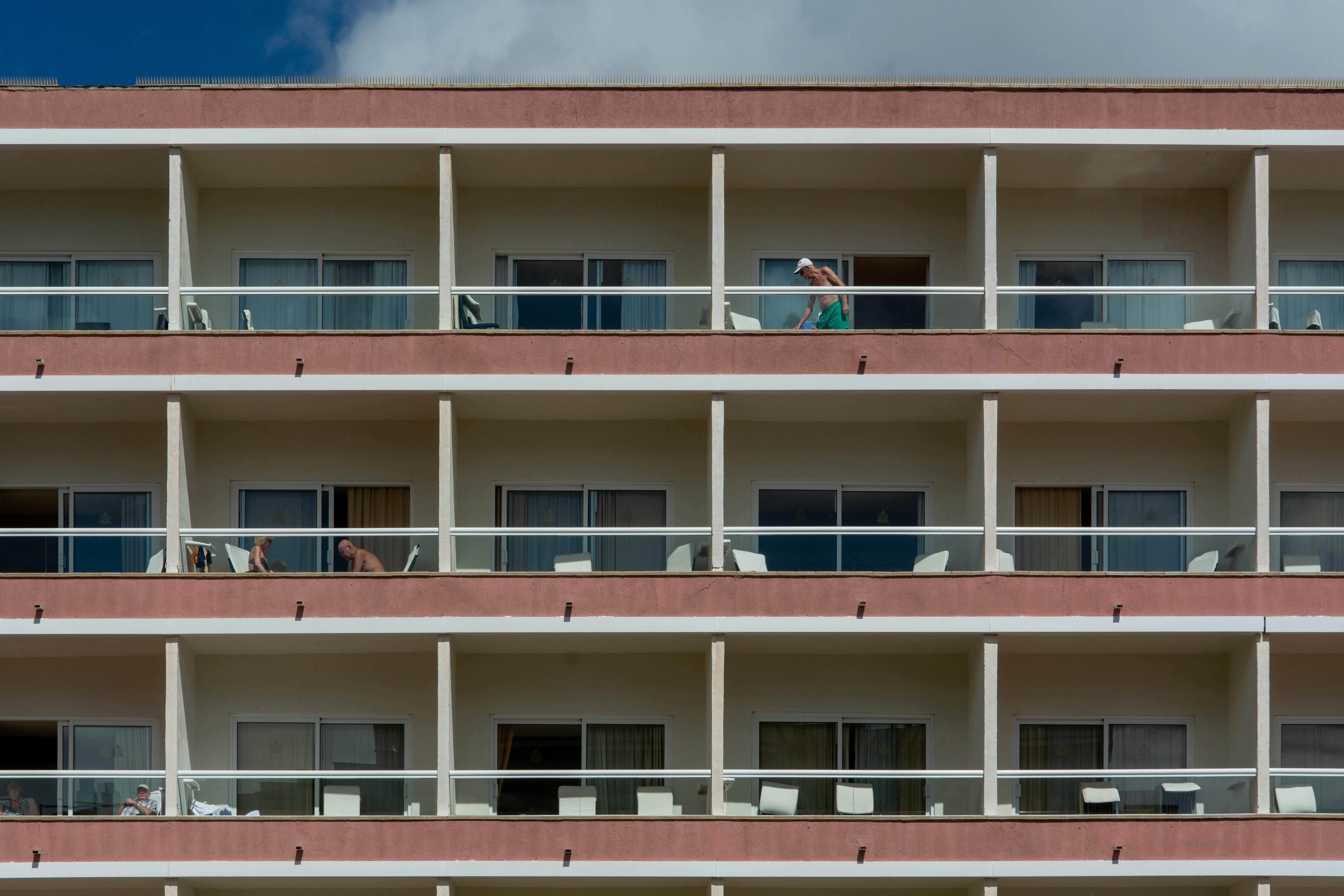 Modern apartment building featuring balconies, highlighting city living.