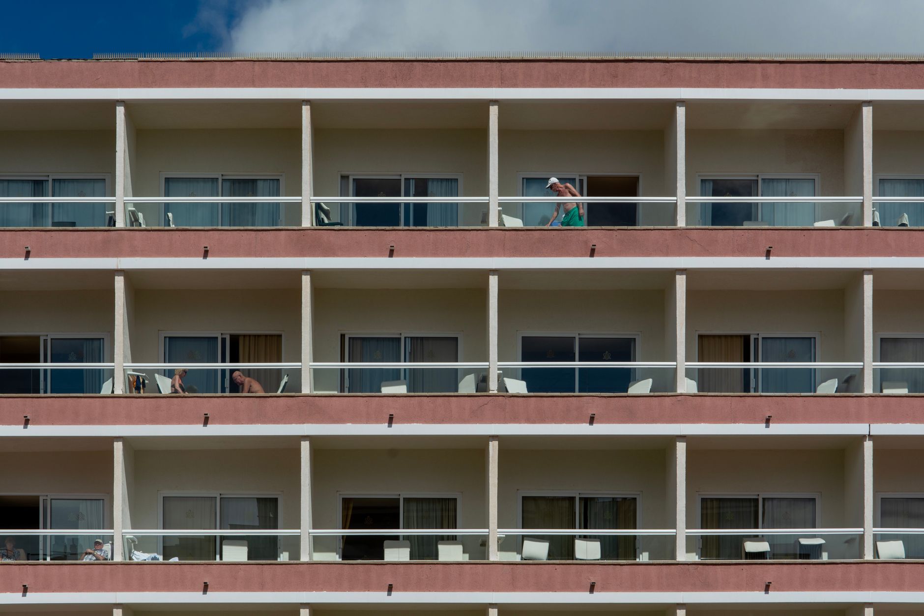 Modern apartment building featuring balconies, highlighting city living.