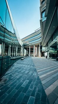 Sleek modern architecture with glass facades and reflections in a financial district.