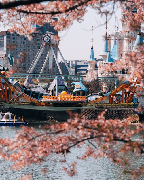 View of the Lotte World Magic Island between Cherry Blossom Branches in Seoul, South Korea