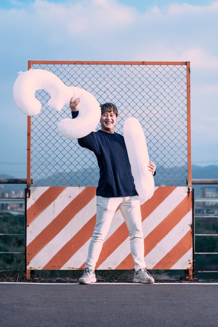 Man Holding Inflatable Numbers 3 An 1 