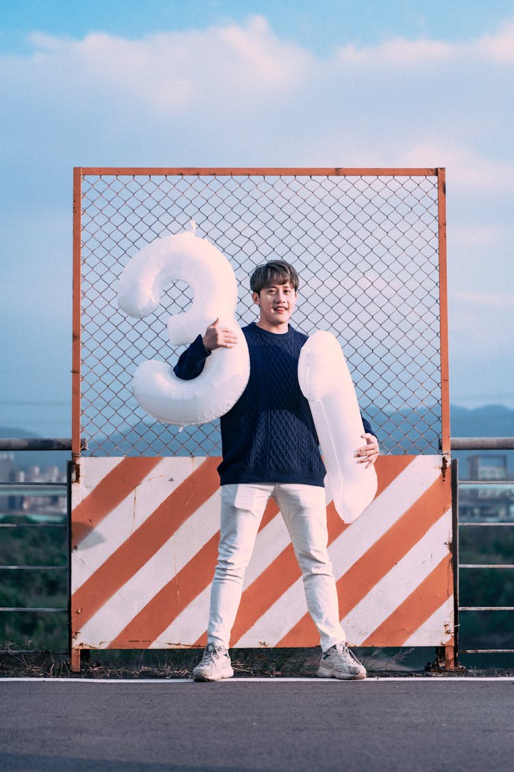 Photo Of A Man Holding Number Balloons