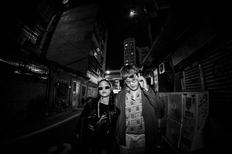 Woman And Man Posing In City At Night