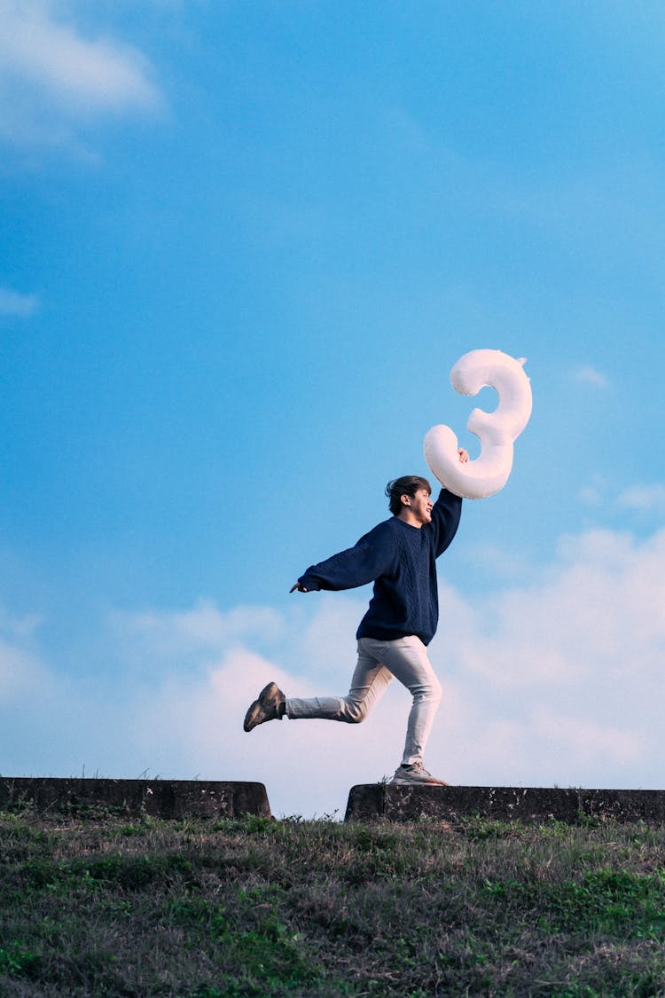 Person Posing With Birthday Balloon