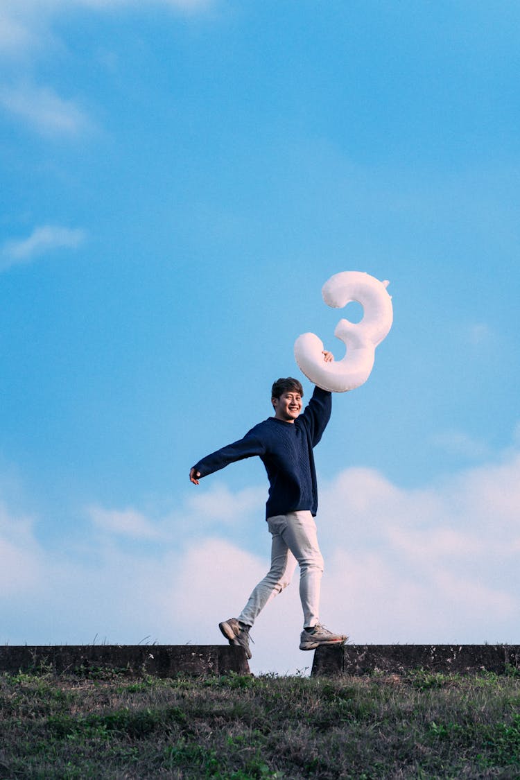 Person Posing With Birthday Balloon