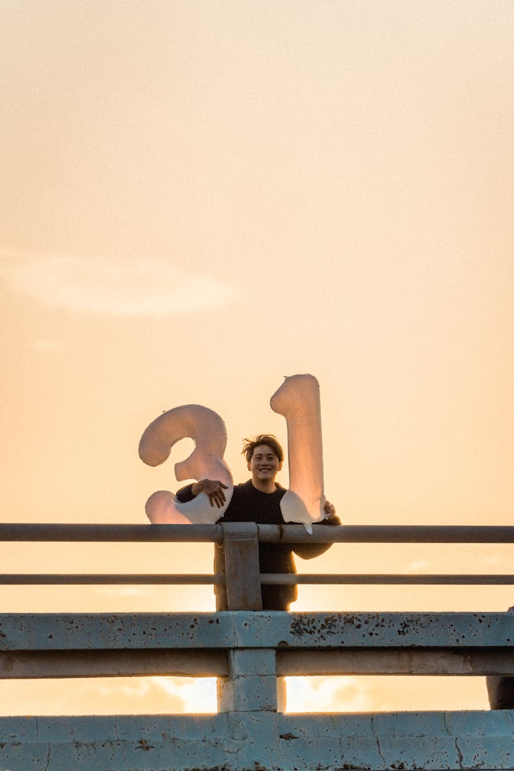 Happy Man Holding Inflatable Numbers