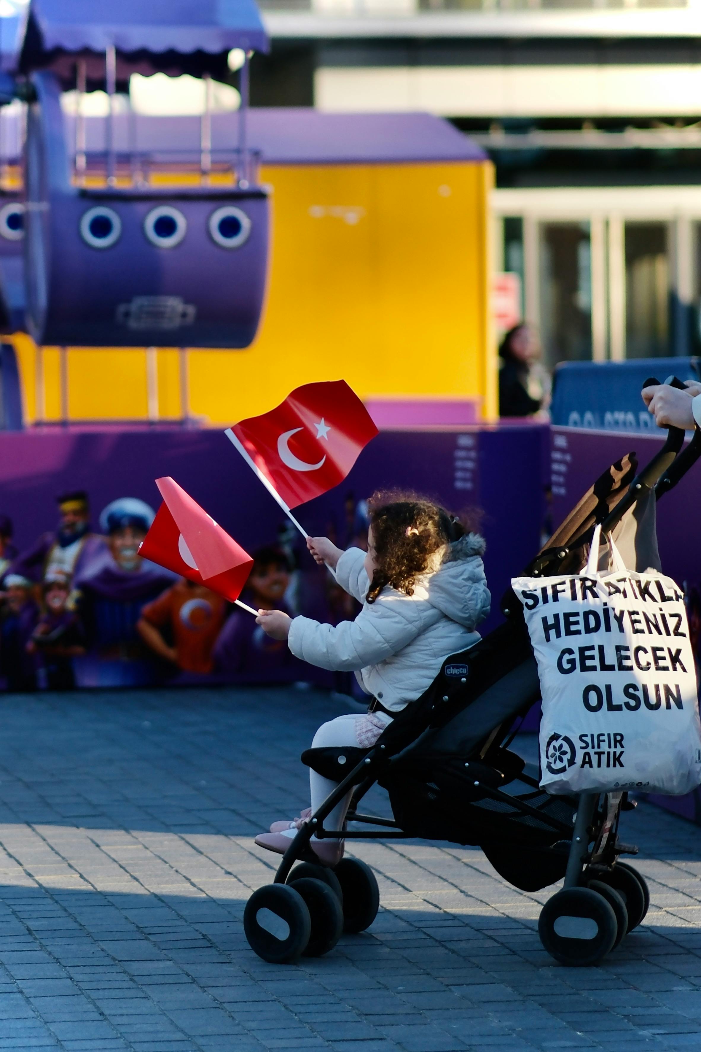 girl in stroller with flags of turkey