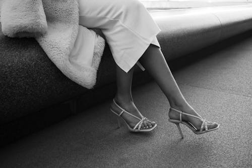 Woman in High Heels Sitting on Bench