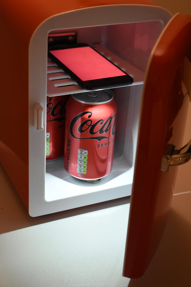 Red Coca-Cola Can In A Small Fridge