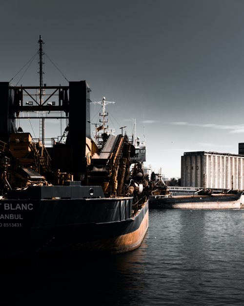 Cargo ship moored in harbor at dusk