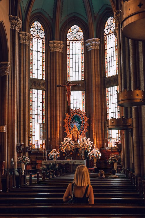 A Blonde Woman Sitting in a Church