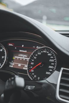 Detailed view of a car's speedometer and dashboard indicating speed and vehicle performance.