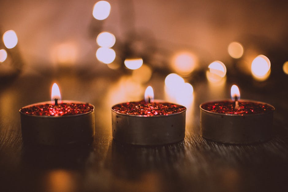 Red glittery flickering flameless LED tealight candles add a cozy, festive touch to a stylish and inviting tablescape.