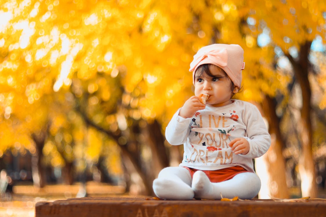 Free Baby Sitting on Top of Table Stock Photo