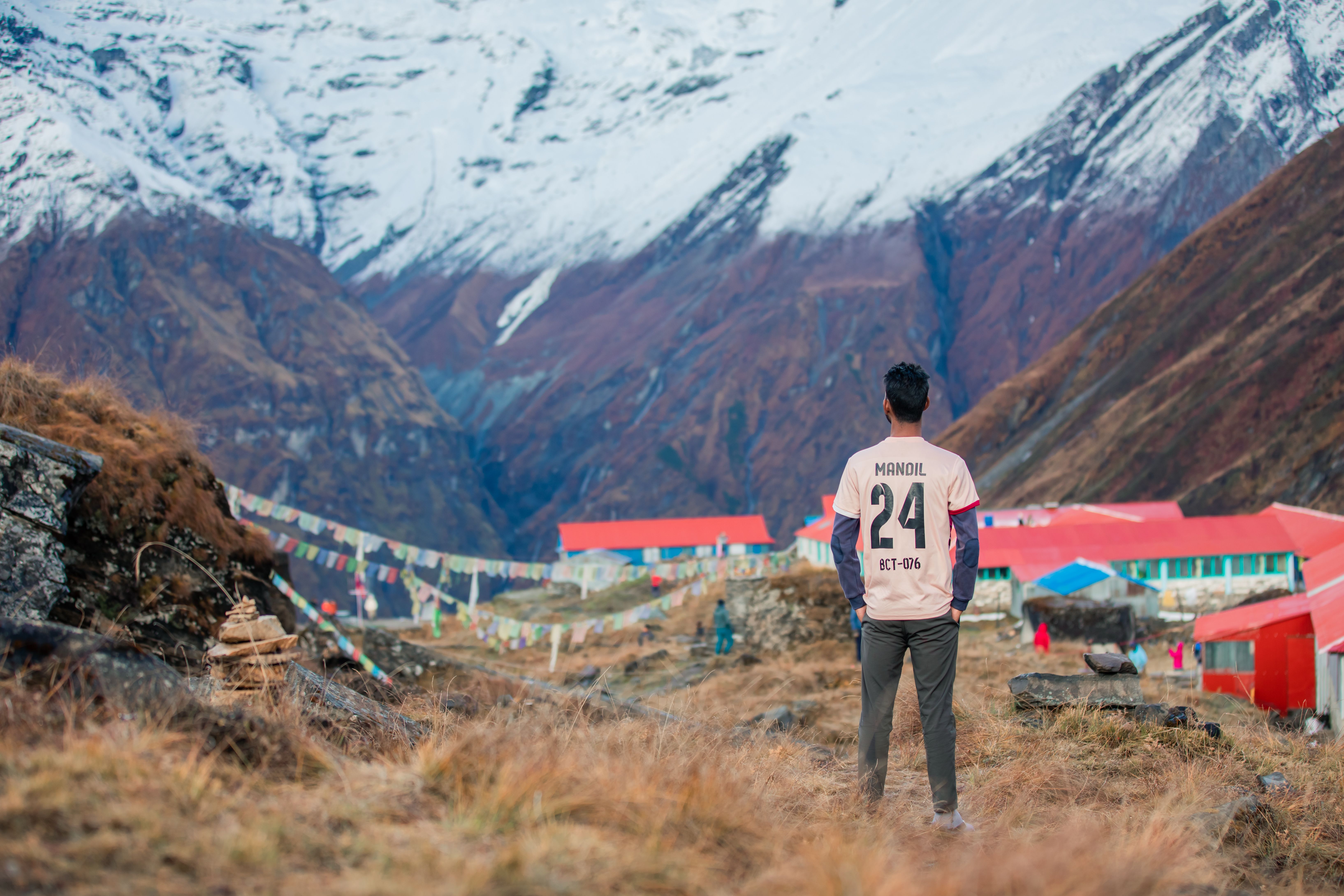 young traveler walking through a quiet mountain village in Nepal at sunrise