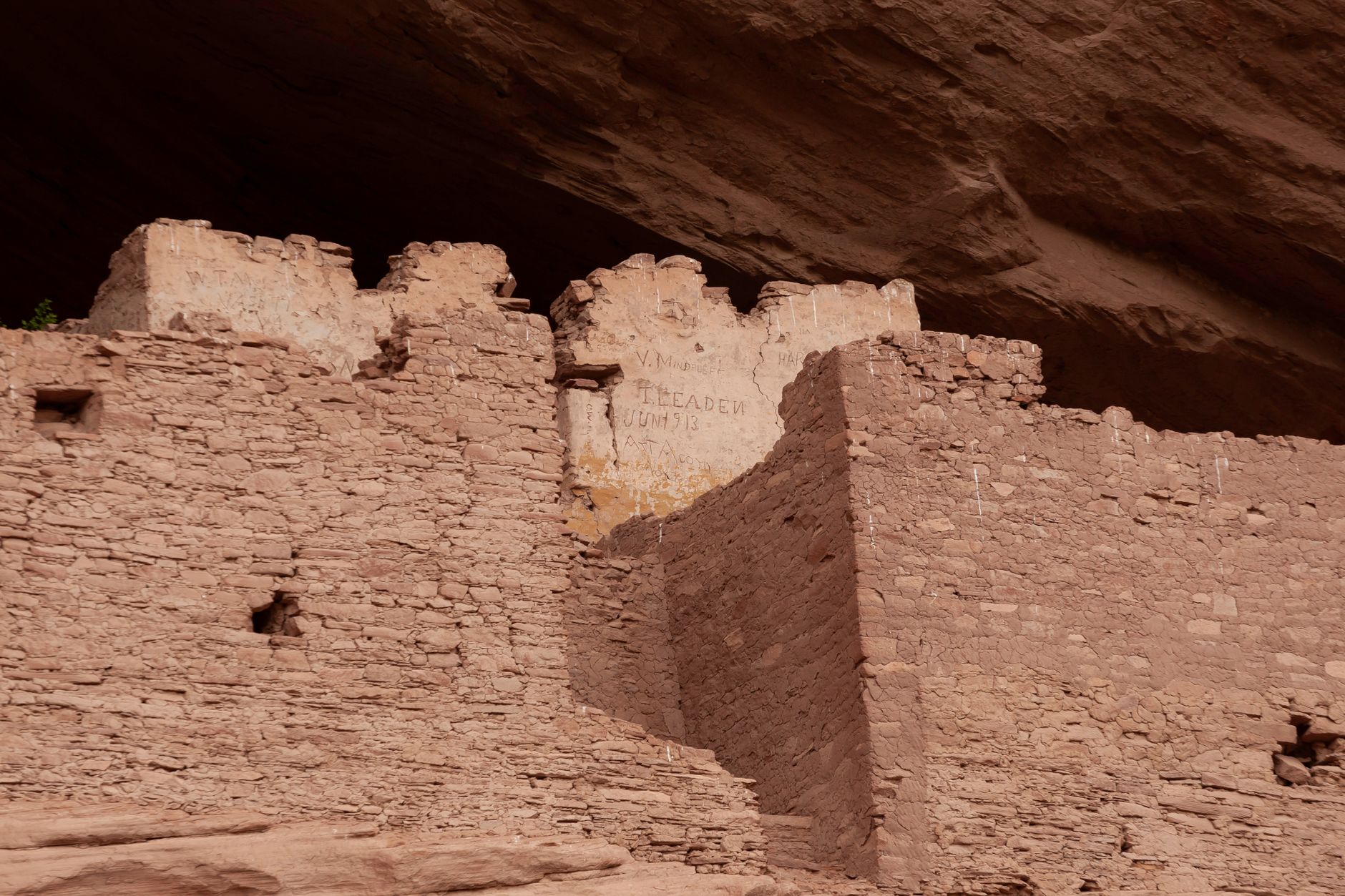 Explore ancient ruins in a canyon near Chinle, Arizona, highlighting weathered rock structures.