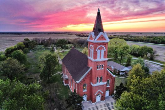 Stunning aerial view of St. Martin's Catholic Church in Piqua, Kansas during sunset.
