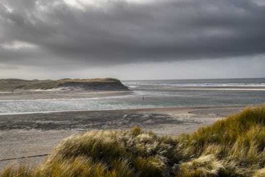 A breathtaking view of a stormy coastal landscape with waves crashing on the shore.