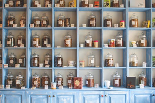 Organized display of herbal tea jars on vibrant blue shelves in a shop.