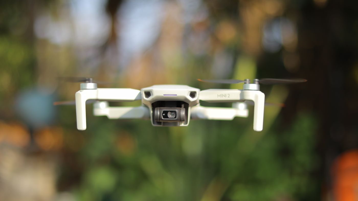 Drone UAV flying aerial survey mission over open landscape