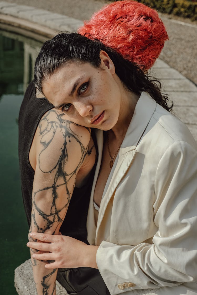 Woman In Elegant Jacket Embracing Punk With Tattoo