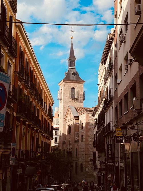Free A picturesque alley view of a historic church in vibrant Madrid, Spain. Stock Photo